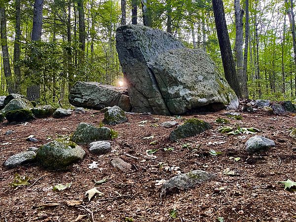 A striking rock formation that appears to swallow the setting sun during the summer solstice.